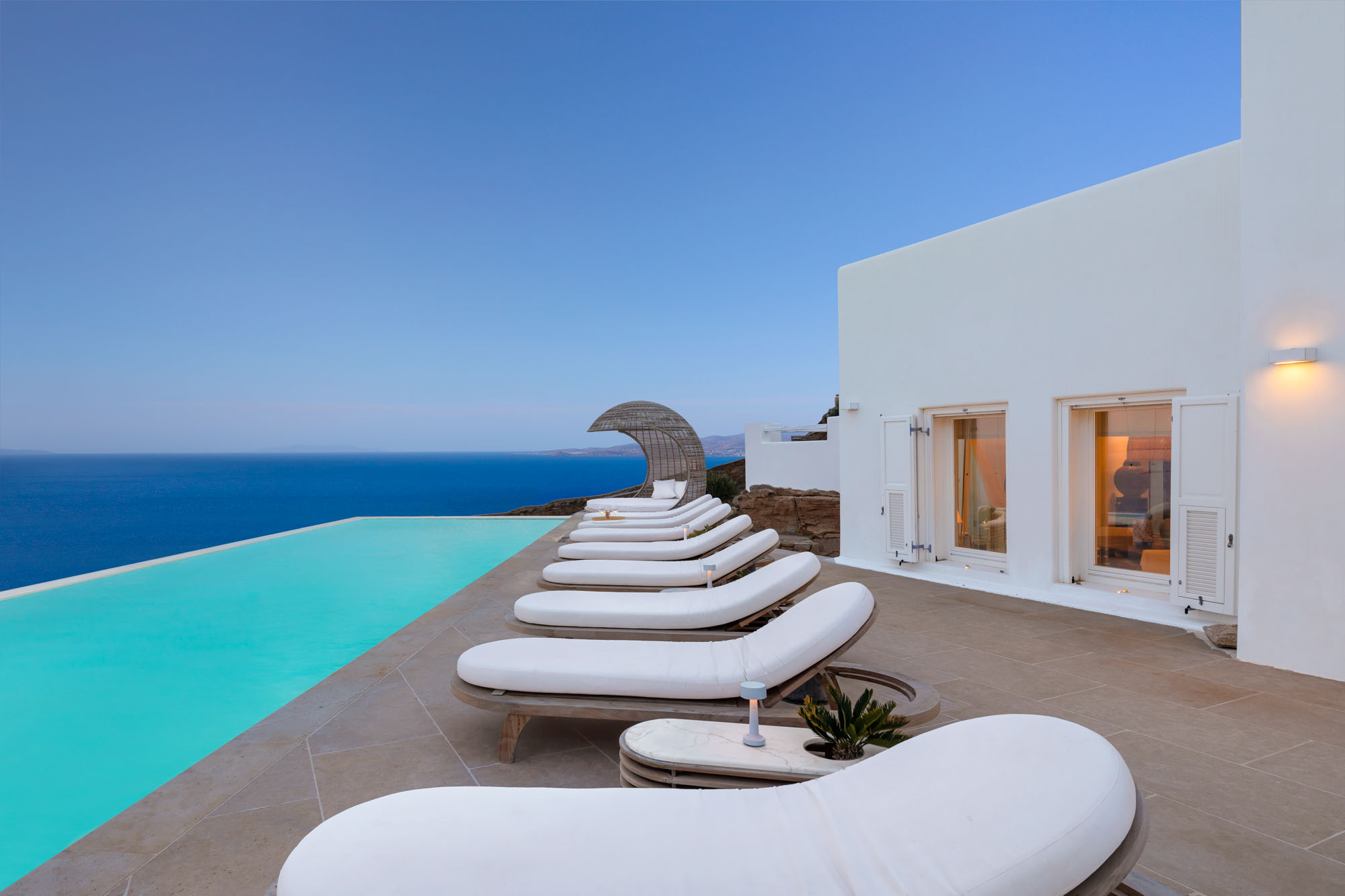 Pool loungers at dusk